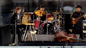 Bob Dylan, left, plays the keyboards with his band and sings a sweet melody as the final act of SunFest 2003 on the Washington