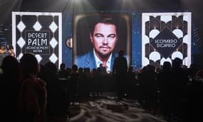 A photo of Leonardo DiCaprio is shown after the actor was unable to attend the awards in person during the Palm Springs