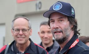 Keanu Reeves talks to fans in the garage area Sunday, May 25, 2025, ahead of the 109th running of the Indianapolis 500 at