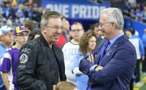 Comedian and Actor Tim Allen, left, talks with Detroit Lions president Rod Wood before the game against the Minnesota Vikings on