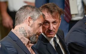 Actor Sean Penn talks to former Washington Metropolitan Police Department officer Michael Fanone during a public hearing before