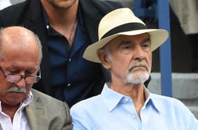 Sep 11, 2015; New York, NY, USA;  Movie actors Bradley Cooper (back) and Sean Connery (front) watch the match between Novak