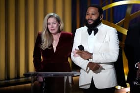 Emmys host Anthony Anderson, right, accompanies Christina Applegate to present best supporting actress in a comedy series on