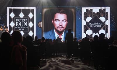 A photo of Leonardo DiCaprio is shown after the actor was unable to attend the awards in person during the Palm Springs