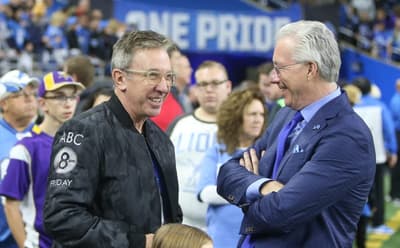 Comedian and Actor Tim Allen, left, talks with Detroit Lions president Rod Wood before the game against the Minnesota Vikings on