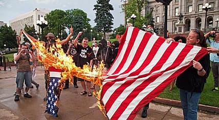 protesters burning american flag