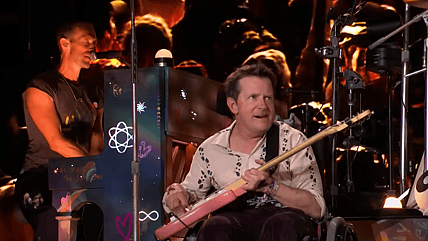 Michael J. Fox rocks the stage at Glastonbury with Coldplay, playing guitar on two iconic songs. Watch the unforgettable performance now.