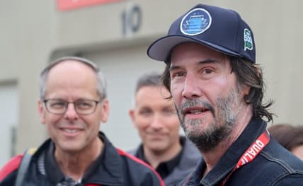 Keanu Reeves talks to fans in the garage area Sunday, May 25, 2025, ahead of the 109th running of the Indianapolis 500 at