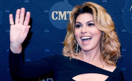 Honoree Shania Twain waves to some fans on the CMT Artist of the Year Awards show's red carpet at Schermerhorn Symphony Center