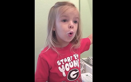 little girl eats donut