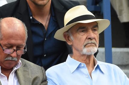 Sep 11, 2015; New York, NY, USA; Movie actors Bradley Cooper (back) and Sean Connery (front) watch the match between Novak