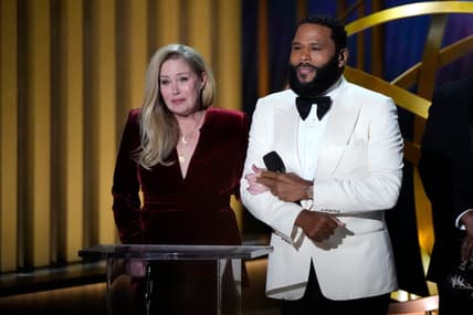 Emmys host Anthony Anderson, right, accompanies Christina Applegate to present best supporting actress in a comedy series on