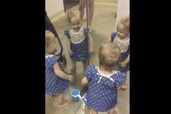 baby sees self in mirror