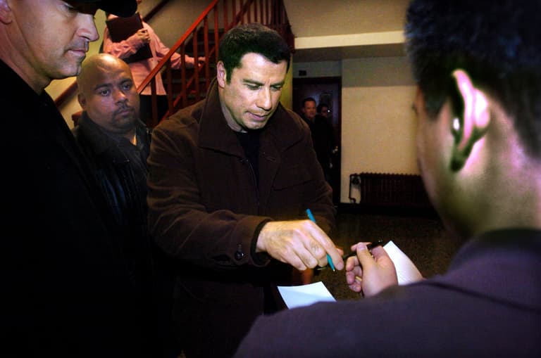 Dec 6, 2004; Englewood, NJ, USA; John Travolta at Dwight Morrow H.S.   John Travolta signs an autograph after finishing an
