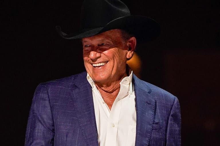 George Strait presents Vince Gill with the Lifetime Achievement Award during the 59th Annual CMA Awards at Bridgestone Arena in