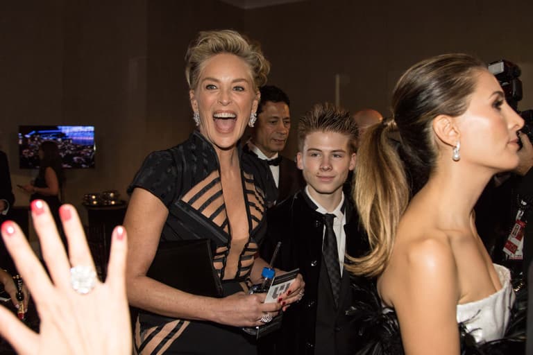 Jan 7, 2018; Beverly Hills, CA, USA; Sharon Stone arrives with her son, Roan Joseph Bronstein, in the International Ballroom for