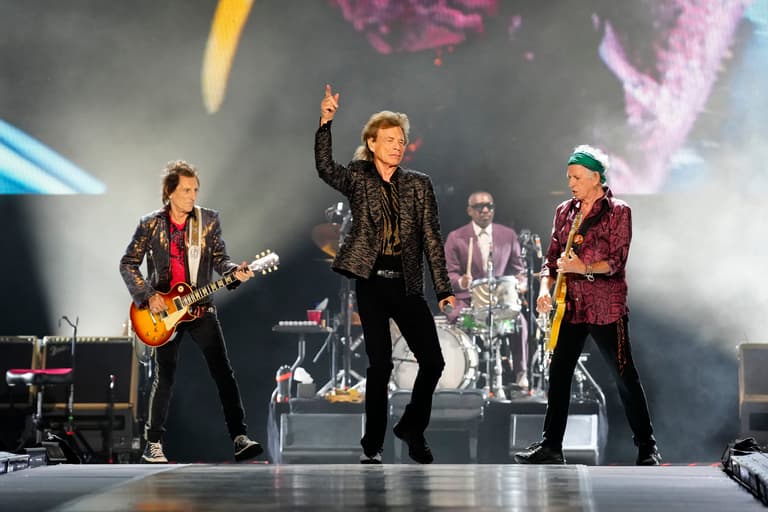 Mick Jagger is shown in front of Ronnie Wood and Keith Richards, during the Rolling Stones concert at MetLife Stadium, Thursday,