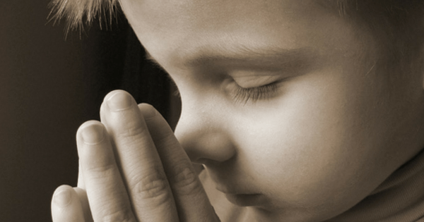 young boy praying