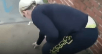 Woman Picks Up Dog Poop