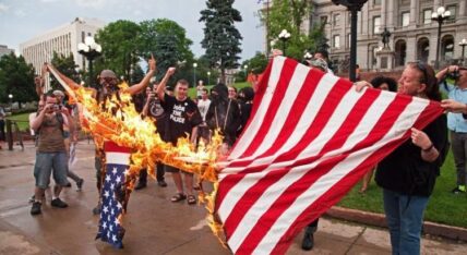protesters burning american flag