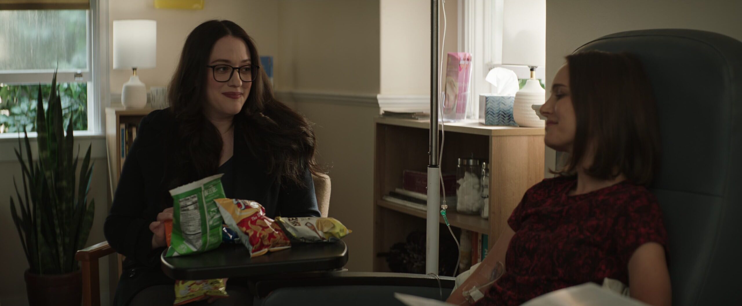 Darcy Lewis (Kat Dennings) keeps Jane Foster (Natalie Portman) company during chemotherapy in Thor: Love and Thunder (2022), Marvel Entertainment