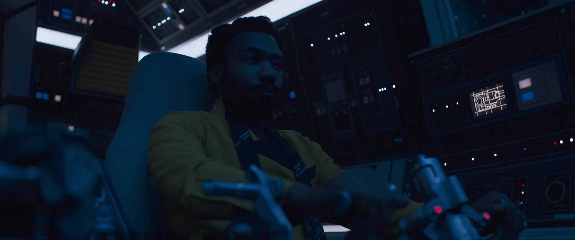 Lando Calrissian (Donald Glover) gets behind the controls of the Millenium Falcon in Solo: A Star Wars Story (2018), Lucasfilm